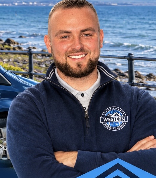 Antóin Ó Mongáin, Company Director of Western Property Solutions, wearing the company fleece by the sea